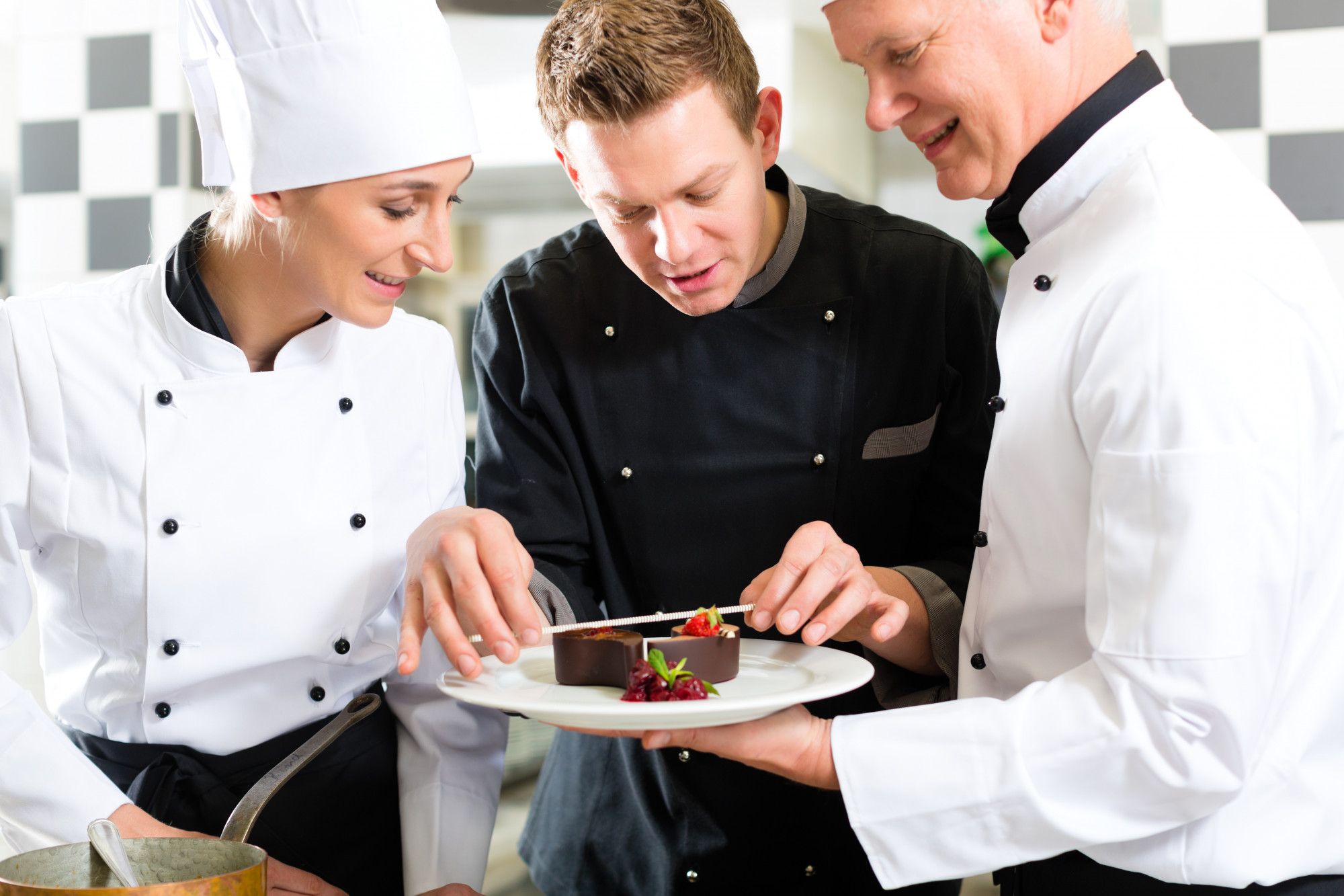 Students plating under chef guidance